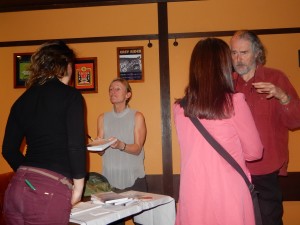 Amy hands over a book while Ken Rodgers of Kyoto Journal discusses coming issues